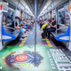 Commuters ride a League of Legends themed subway car in China.